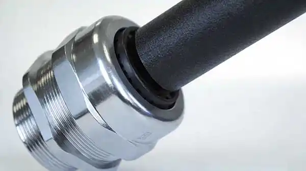 Close-up of a cable gland and sealing insert at a solar combiner box entry